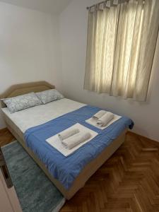 Postel nebo postele na pokoji v ubytování Apartmani Jedro