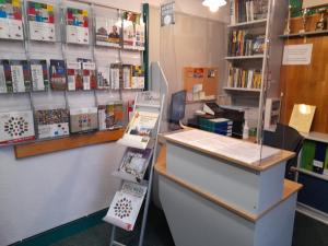 a book store with a counter and shelves of books at Youth Hostel Podlasie in Białystok