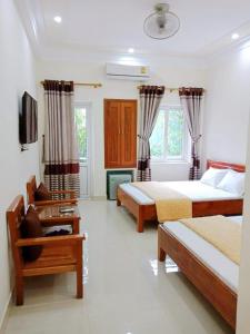 a bedroom with two beds and a tv in it at Thành Đạt Hotel in Cửa Lò