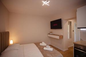 Postel nebo postele na pokoji v ubytování City Center Studio Apartments