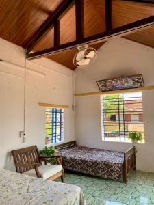 a bedroom with two beds and two windows at Ecohost Đông Hòa in Phú Hiệp