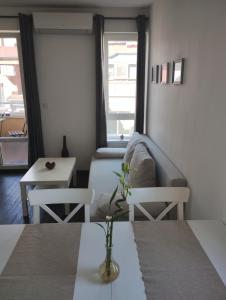 a small room with a bed and a table at Happy Apartment & Free Breakfast - Mladost in Sofia