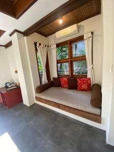 a bed in a room with a window at Tegal Sari Accommodation Ubud in Ubud