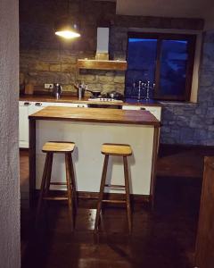 a kitchen with a counter and two stools at a island at Villa Toscana in Gokceada Town