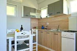 a small kitchen with a sink and a counter at Tina in Cetinje