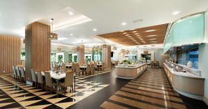 a restaurant with a dining room with tables and chairs at Nilai Springs Resort Hotel in Nilai