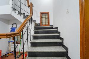 a stairway in a home with a stair case at FabExpress Harma Residency in Chennai