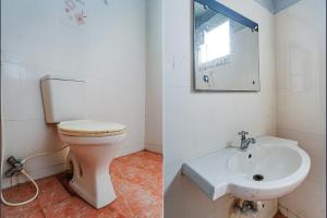 a bathroom with a toilet and a sink at FabExpress Chennai Central in Chennai