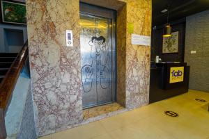 a door in a building with graffiti on it at FabExpress Chennai Central in Chennai