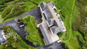 an overhead view of a building with cars in a parking lot at Journeys End with surrounding Sea views in Coverack