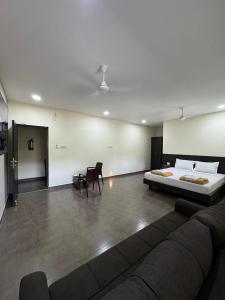 a living room with a bed and a couch at Sangeetha Business Hotel in Chennai