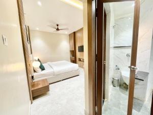 a hotel room with a bed and a shower at HOTEL VEDANGAM INN ! VARANASI - Forɘigner's Choice ! fully Air-Conditioned hotel with Parking availability, near Kashi Vishwanath Temple, and Ganga ghat 2 in Varanasi