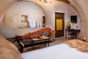 A bed or beds in a room at Cappadocia Pegasos Cave Suite Hotel