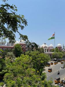 a view of a city street with buses and a flag at Sangeetha Business Hotel in Chennai +79 photos