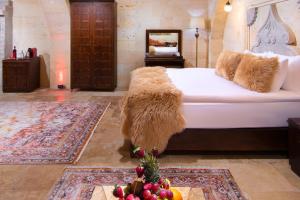 A bed or beds in a room at Cappadocia Pegasos Cave Suite Hotel