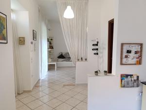 a hallway with white walls and a tile floor at Casa con ampio giardino e patio in Acerra