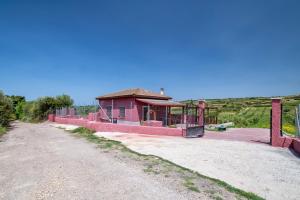 a small building on the side of a dirt road at The Secret Path in Sorso