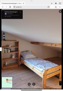 a bedroom with a bunk bed and a book shelf at Ferienhaus Bartelshagen 1 in Marlow