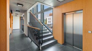 a hallway of a building with stairs and a window at Apartamenty Sun & Snow Kaszubska Bryza ll in Hel