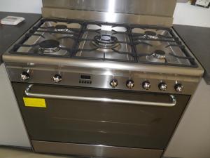 a stainless steel stove top oven in a kitchen at Villa neuve piscine chauffée - St Vallier de Thiey in Saint-Vallier-de-Thiey