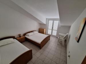 Postel nebo postele na pokoji v ubytování Anic Apartments Stanići