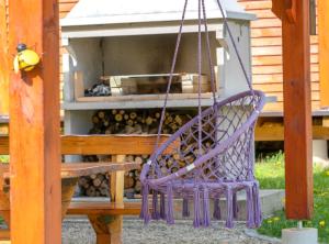 a purple swinging chair in front of a fire hydrant at Robinzonski Kamp Hofman in Varaždin