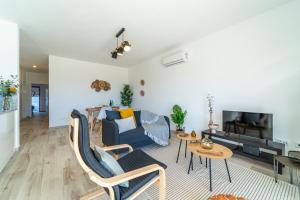 a living room with a blue couch and a table at Apartment Nascer do Sol in Aljezur