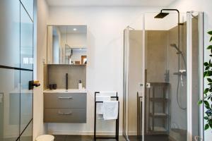 a bathroom with a shower and a sink at Schönauer Hof - Wohnung Rosalie in Passau +14 photos