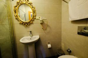a bathroom with a mirror and a sink at Taksim Celebi Suites in Istanbul