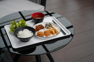 a tray of food on a table with rice and meatballs at Kokotel Chiang Rai Airport Suites in Ban Prong Phra Bat Nok