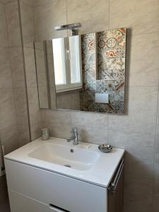 a bathroom with a white sink and a mirror at New Caos Calmo in Rome