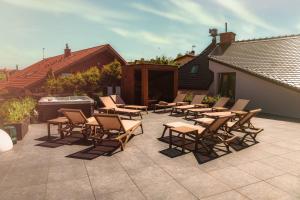 a group of chairs and tables on a patio at Boulevard Boutique Suites in Łeba