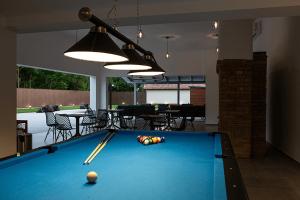 a pool table in a living room with a pool ball at Helyneked in Orosháza