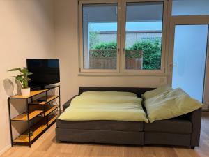 a bed sitting in a room with a window at Loft Neunkirchen in Neunkirchen am Brand