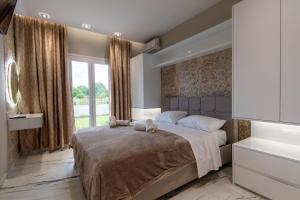 Postel nebo postele na pokoji v ubytování Evelina Luxury Suites in Corfu