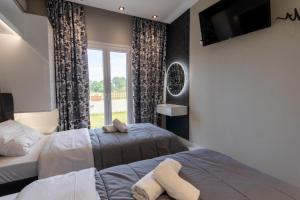 Postel nebo postele na pokoji v ubytování Evelina Luxury Suites in Corfu