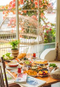 a table with plates of food on it at Palas Alaçatı - Adult Only in Alaçatı