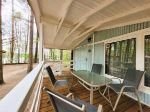 a screened in porch with a table and chairs at Letnisko BAJKA in Makowo