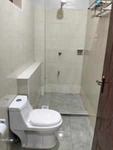 a white bathroom with a toilet and a shower at JNJ luxury homes in Naivasha