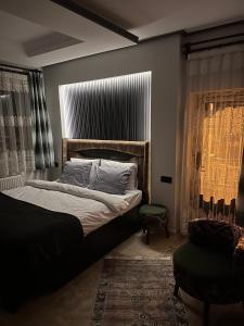 Postel nebo postele na pokoji v ubytování Dirilis Banarya Apart hotel
