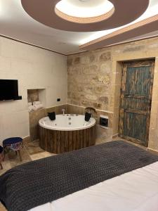Postel nebo postele na pokoji v ubytování Dirilis Banarya Apart hotel