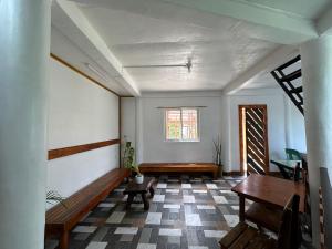 a living room with a bench and a window at Bearbys Homestay Siargao - B in Catangnan