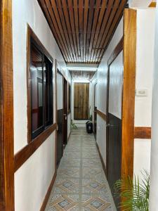 a corridor of a building with a wooden ceiling at Bearbys Homestay Siargao - B in Catangnan