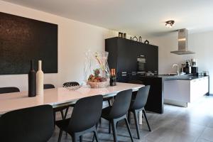 a kitchen and dining room with a table and chairs at Villa contemporaine 7 minutes du Centre de Lille in Marcq-en-Baroeul