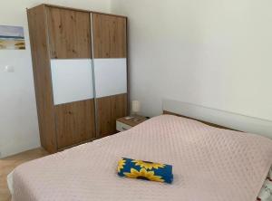 a bedroom with a bed and a wooden cabinet at Apartments Silba in Silba