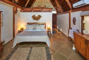 a bedroom with a large bed in a room at Vaayu Kula mandrem in Mandrem