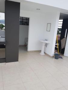 a white bathroom with a sink and a sink at Playa Sur departamento centrico y turistico in Mazatlán +2 photos