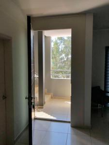 an open door to a room with a window at Playa Sur departamento centrico y turistico in Mazatlán