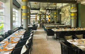 a dining room with long tables and chairs at Ocean's Creek Beach Hotel in Balaclava