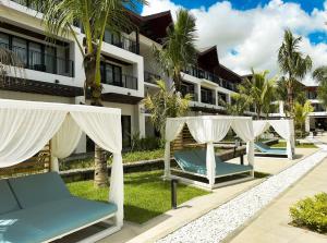 a row of lounge chairs in front of a building at Ocean's Creek Beach Hotel in Balaclava